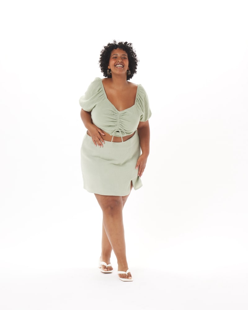 Front of a model wearing a size 3X Melanie Skirt in Sage in Sage Green by What Lo Wants. | dia_product_style_image_id:237939